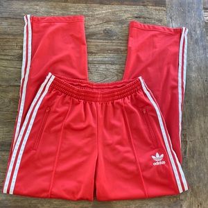 Used red and white Adidas track pants